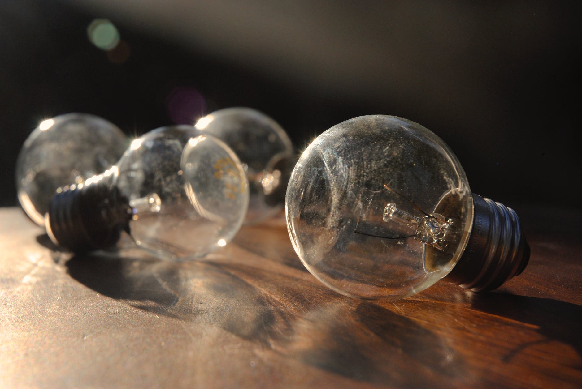 old incandescent electric lamps on wooden table