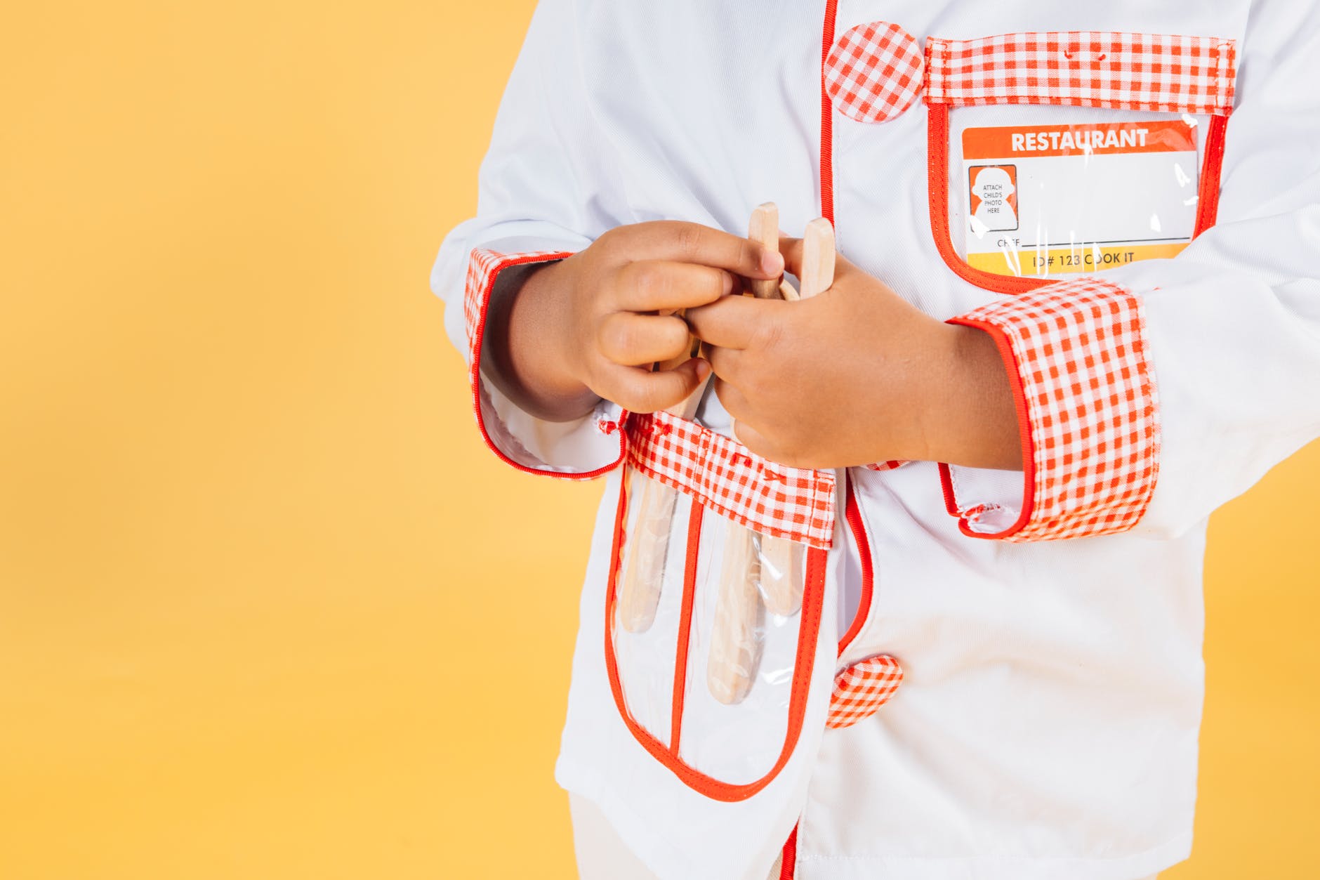 ethnic child wearing white uniform of chef